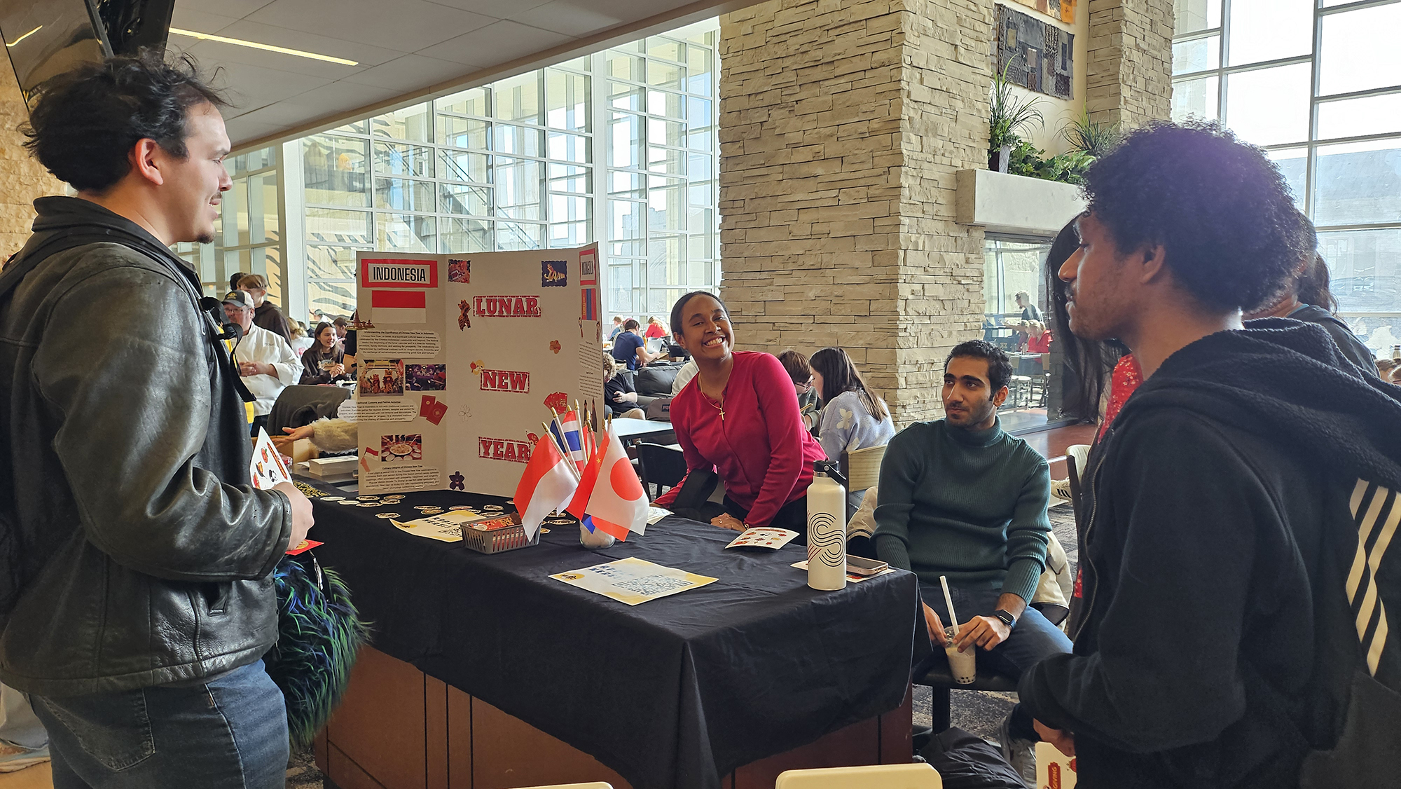 Students look at the Lunar New Year informational display on a table in the MU Student Center.