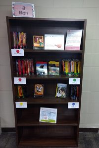 A bookshelf holding the IEP Library books and materials.