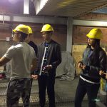 Five students in hardhats look at equipment during a tour of MU's power plant.